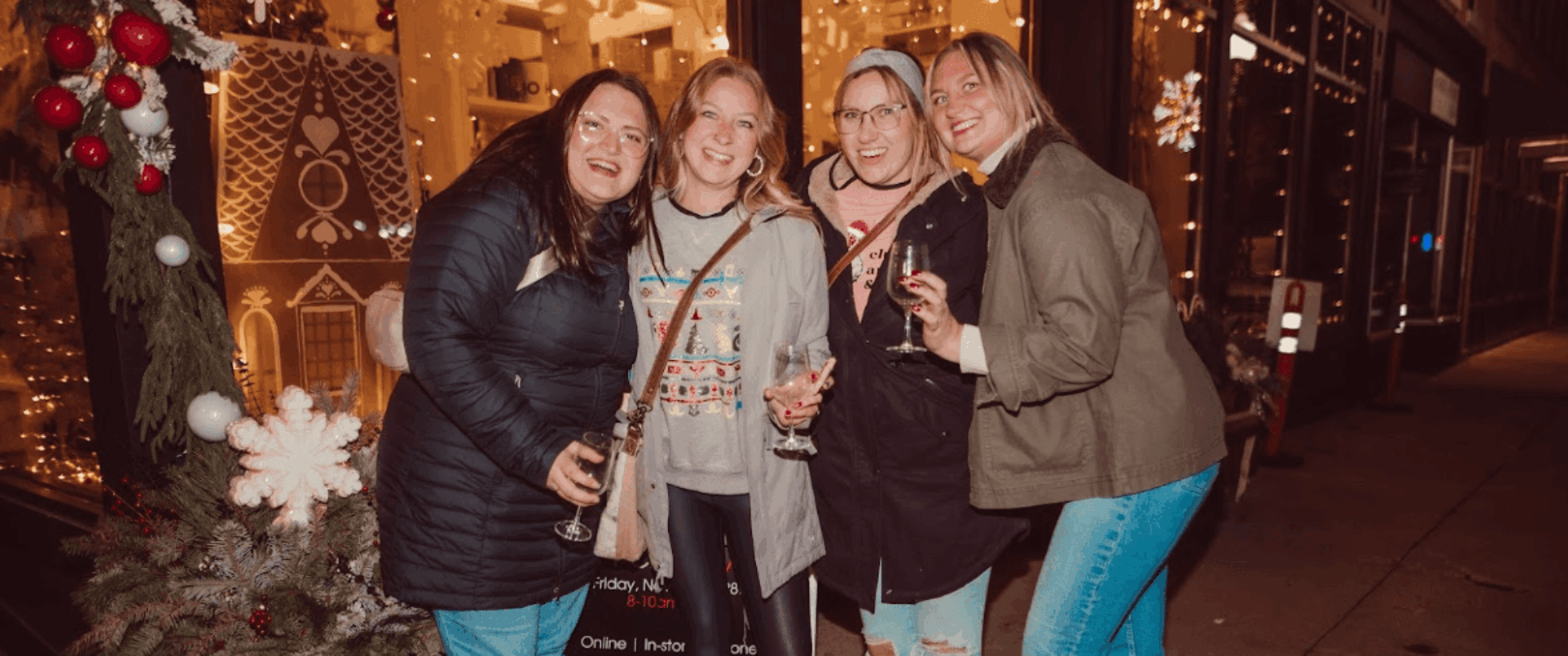 Winter Wine Walk in Baraboo. 4 ladies drinking wine and smiling outside a shop