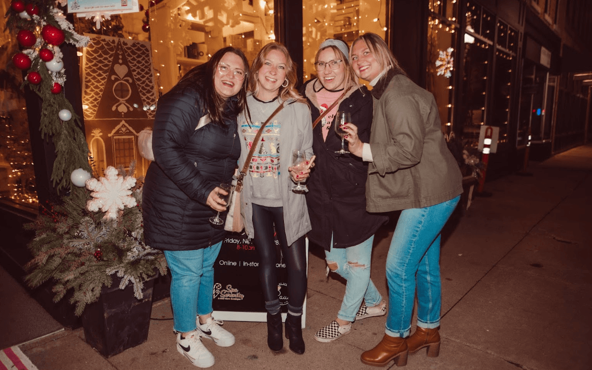 Winter Wine Walk in Baraboo. 4 ladies drinking wine and smiling outside a shop