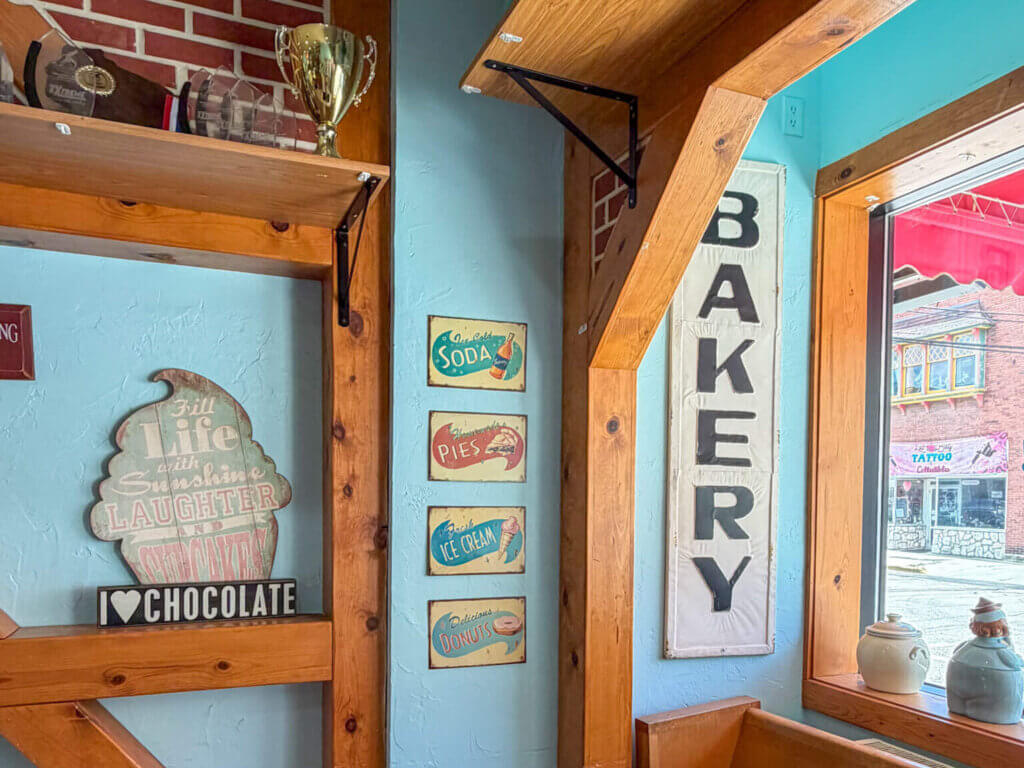 Neat-Os Bake Shoppe in Baraboo where you can get fresh baked pastries and other goods. Shows a bakery sign and blue walls.