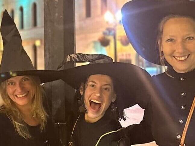Three women dressed up as witches celebrating Witches Night Out in Baraboo, WI.